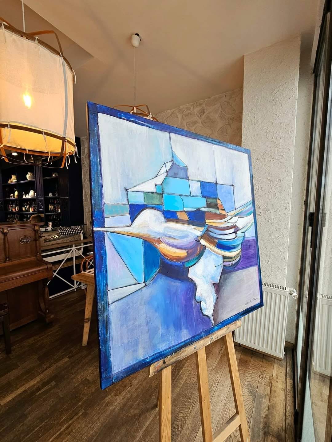 Flight / The Wondrous Bird displayed on an easel beside a window.